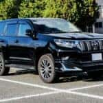 black suv in a parking lot in daytime