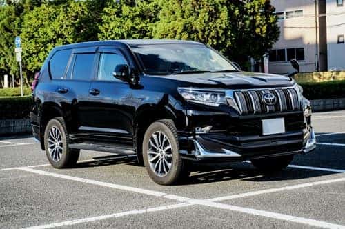 black suv in a parking lot in daytime