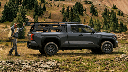Toyota Tacoma with Worker loading tools