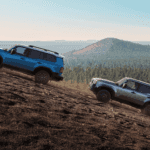 SUVs driving up a steep hill