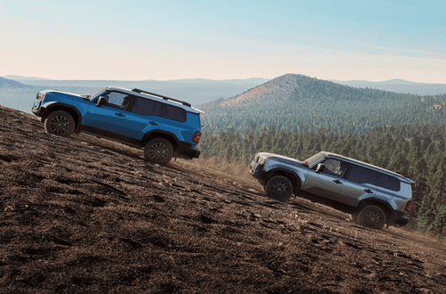 SUVs driving up a steep hill