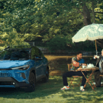 Two men having tea in front of a Toyota SUV