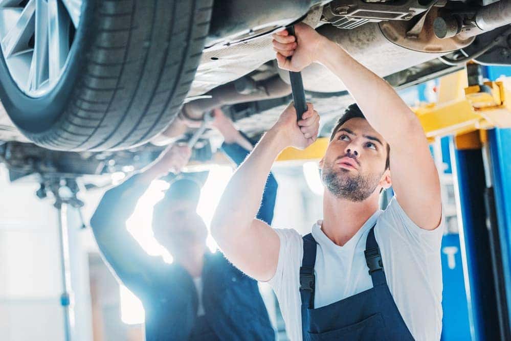 Auto mechanic performing tune up