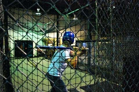 person in a baseball batting cage in louisville ky