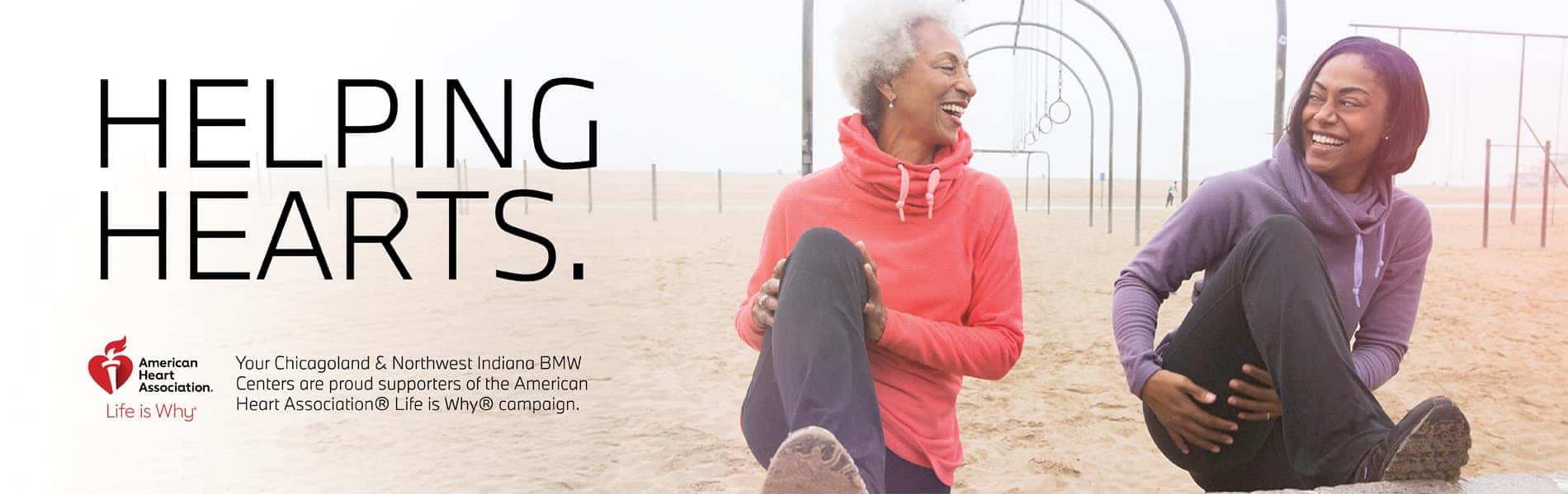 Helping Hearts American Heart Association. Two women sitting on a playground smiling to each other.