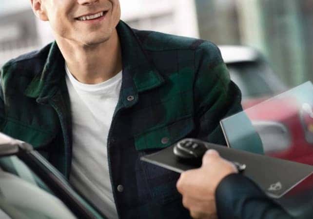 friendly car salesman helping a customer