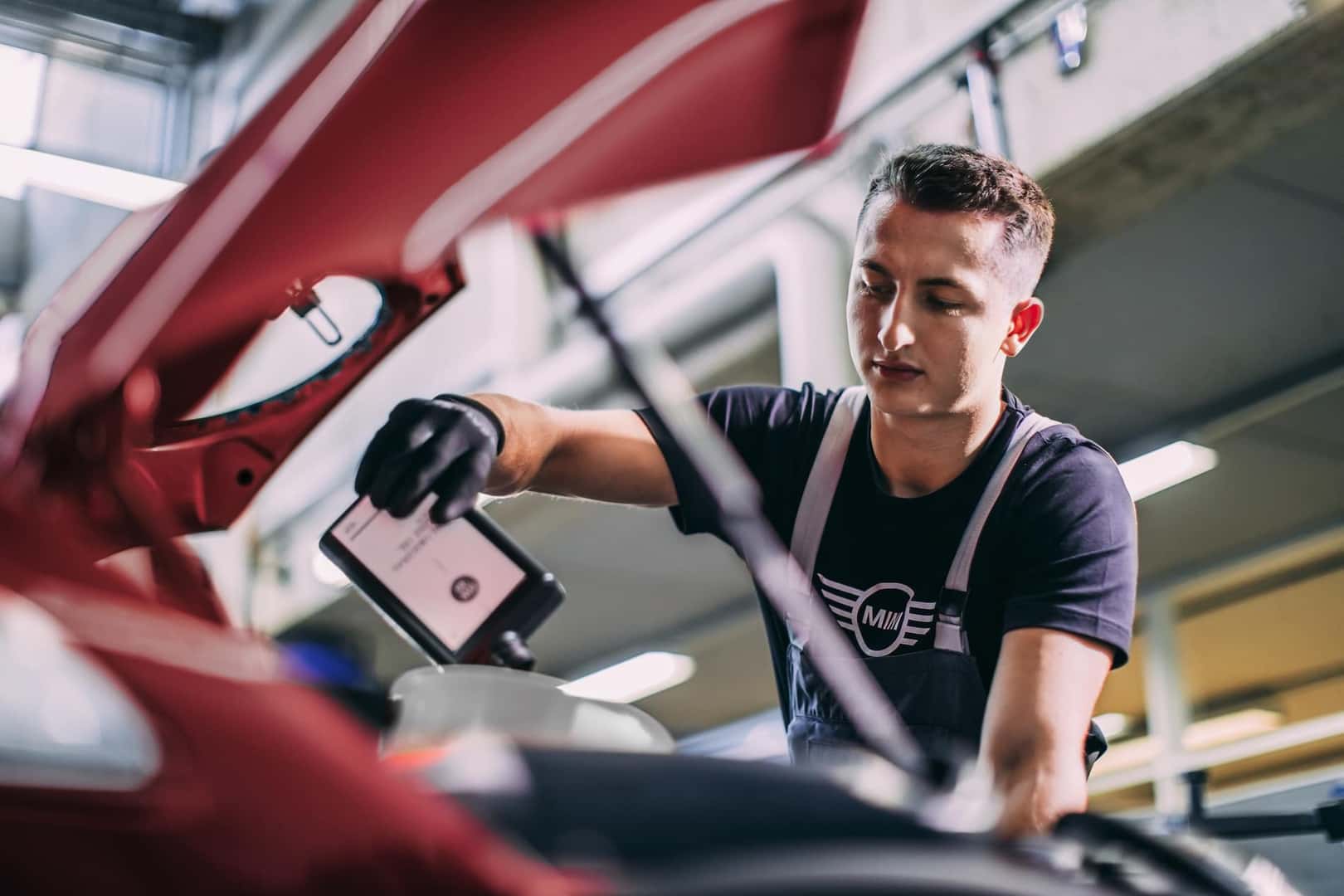 MINI Technician pouring oil into a MINI 