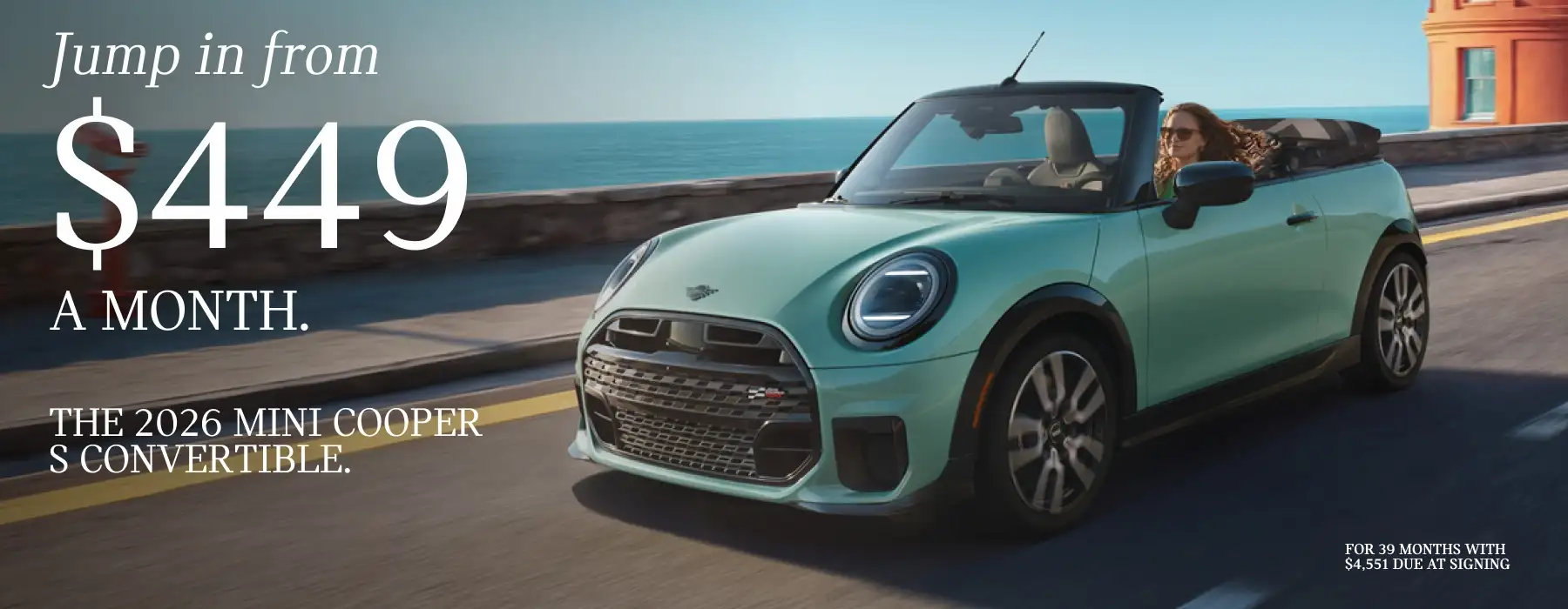 2026 MINI Cooper S Convertible showing a mint-green convertible driving along a coastal road beside the ocean. Large text reads, “Jump in from $449 a month,” with smaller text stating, “The 2026 MINI Cooper S Convertible.” Fine print notes a 39-month lease with $4,551 due at signing.