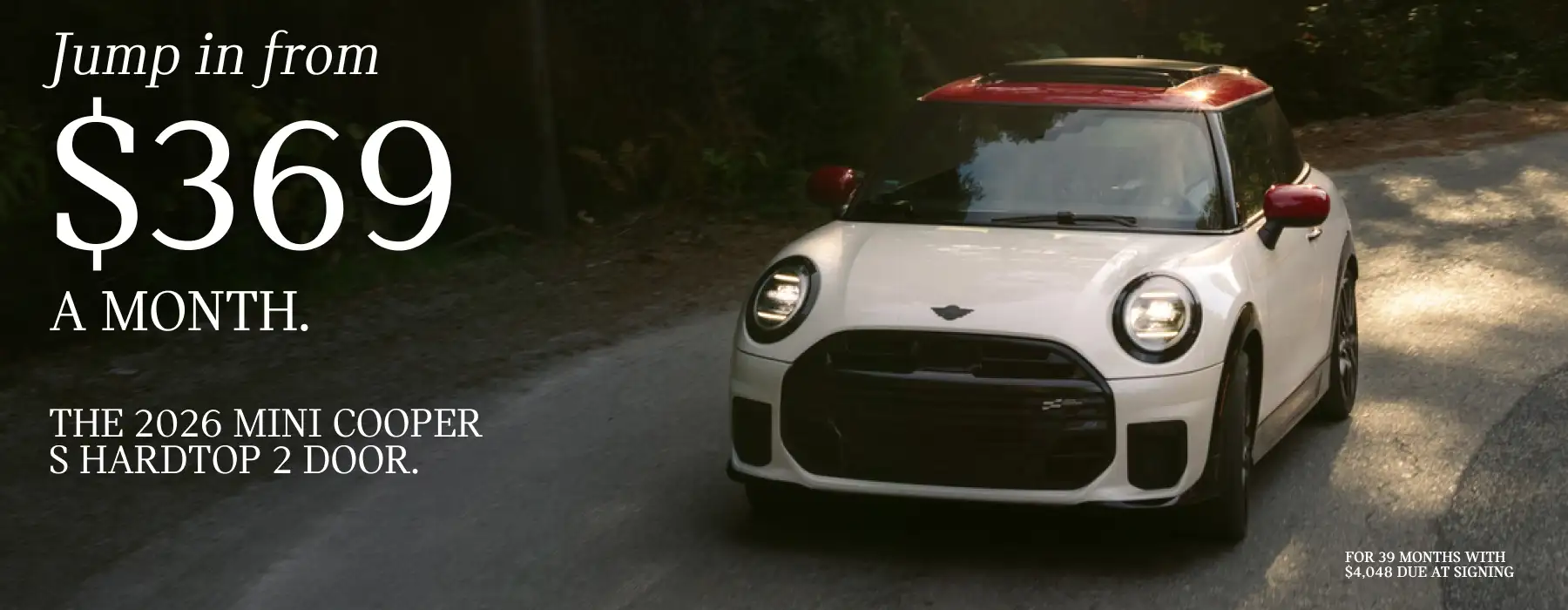 2026 MINI Cooper S Hardtop 2 Door showing a white MINI with a red roof driving along a wooded road. Large text reads, “Jump in from $369 a month,” alongside “The 2026 MINI Cooper S Hardtop 2 Door.” Fine print states a 39-month lease with $4,048 due at signing.