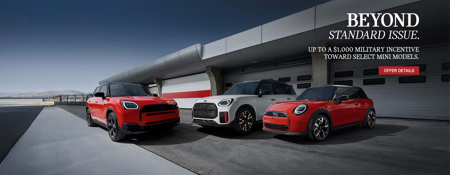 Three MINI's in front of a plane hanger.