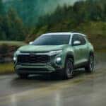 Front View of Green 2025 Equinox Driving Down Scenic Road