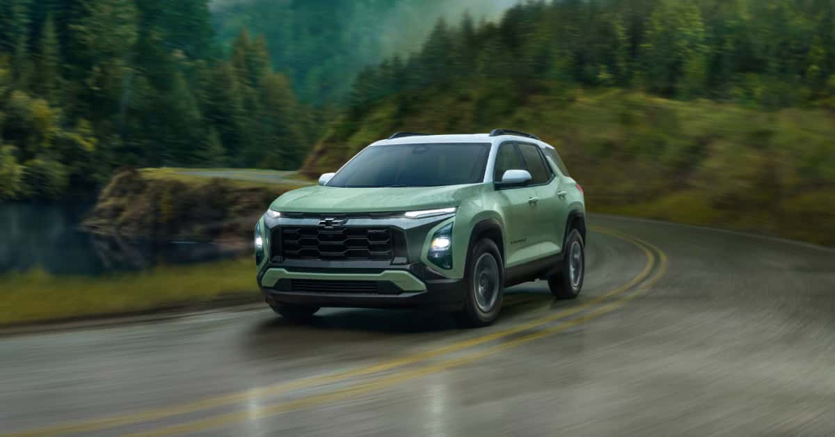 Front View of Green 2025 Equinox Driving Down Scenic Road