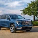 A blue 2026 GMC Acadia parked outdoors