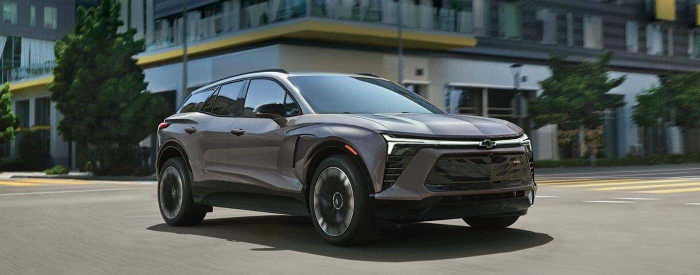 Silver 2025 Chevy Blazer EV RS driving through a city