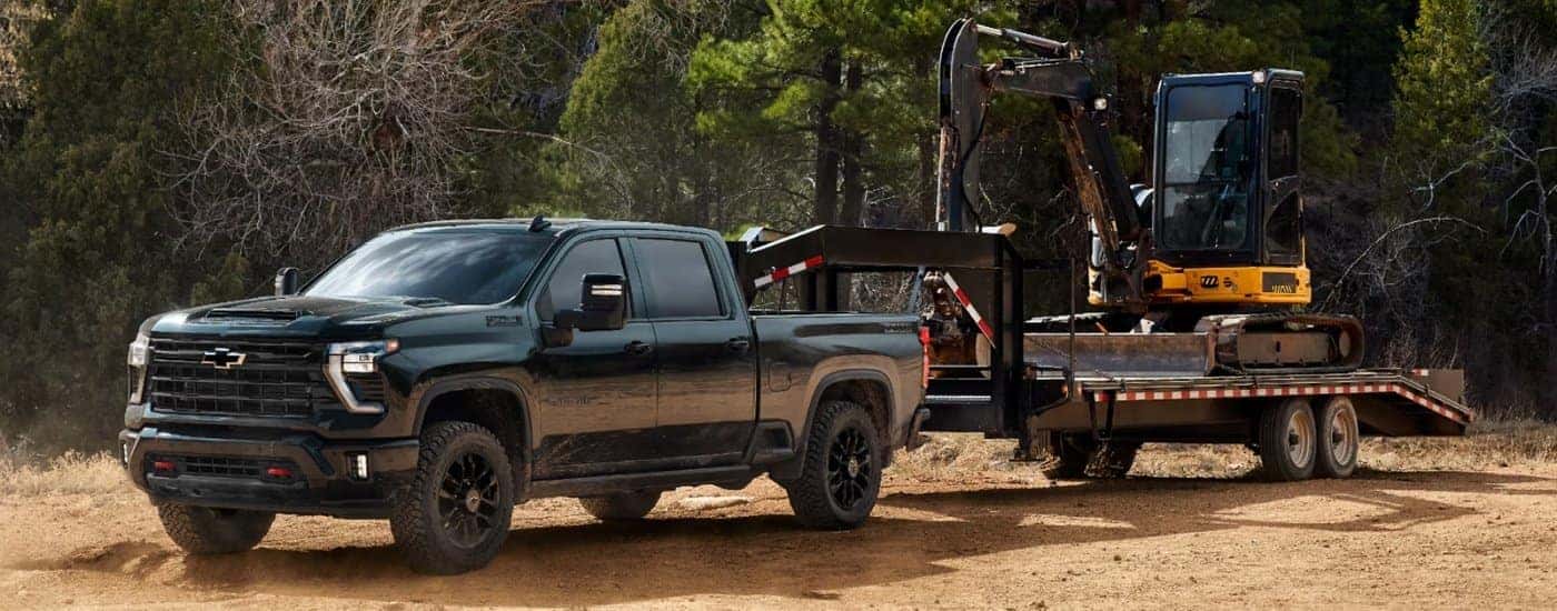 Black 2026 Chevy Silverado 2500 HD LTZ Trail Boss towing a trailer