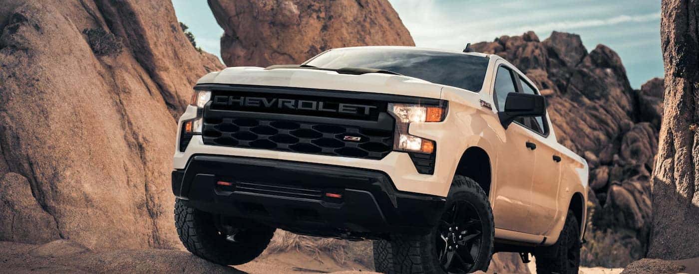 White 2026 Chevy Silverado 1500 Z71 driving off-road.