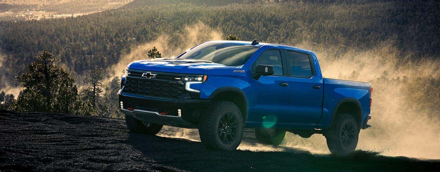 Blue 2026 Chevy Silverado 1500 ZR2 driving off-road.