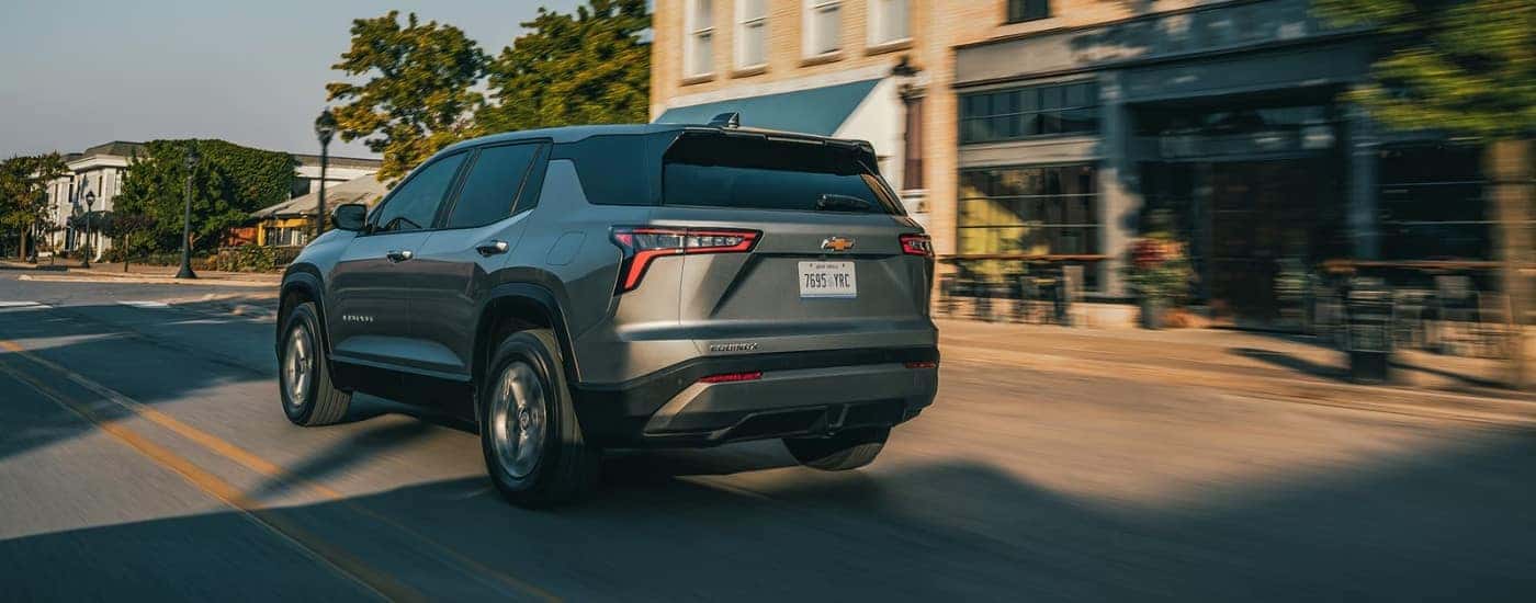 A gray 2026 Chevy Equinox LT shown driving from rear.