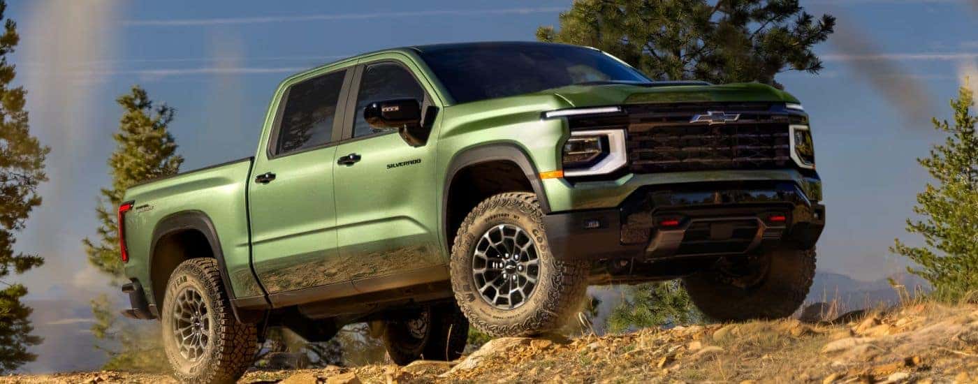 A green 2027 Green Silverado 1500 driving off-road.
