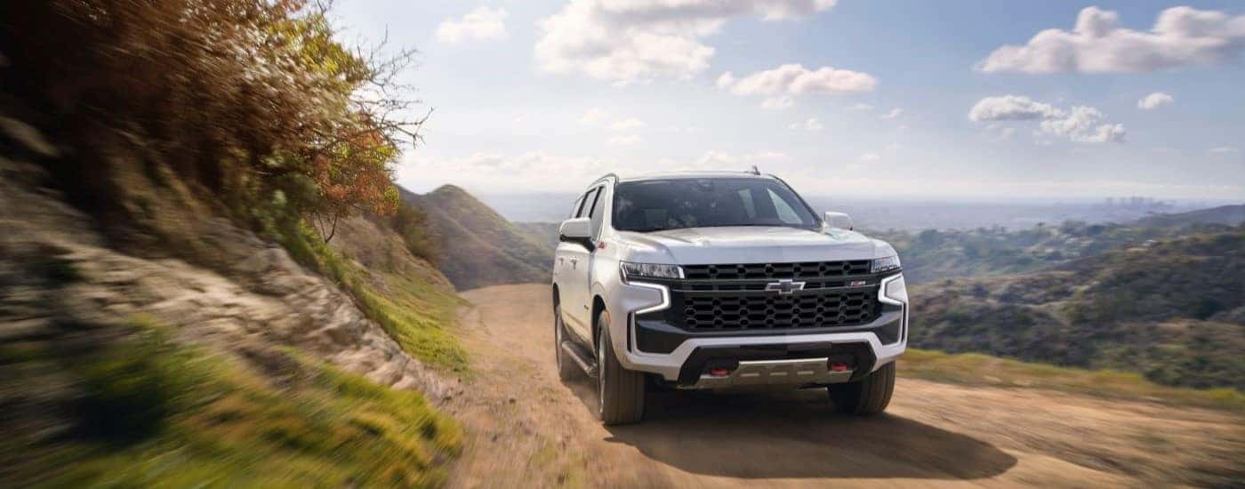 A white 2021 Chevy Tahoe Z71 driving in mountains.