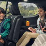 family sitting in a new Toyota Grand Highlander SUV