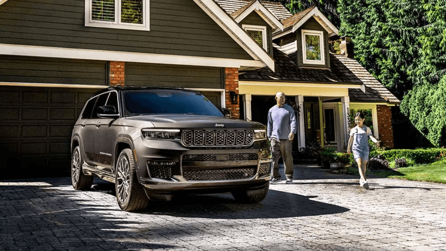 Used Jeep Grand Cherokee from Conklin Newton parked outside a family home in Wichita, KS