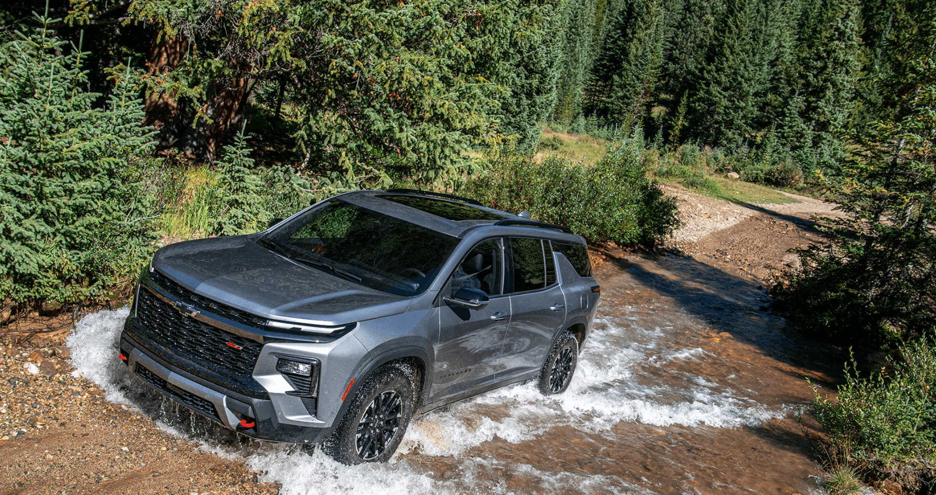 New Chevrolet Traverse driving through mountain terrain