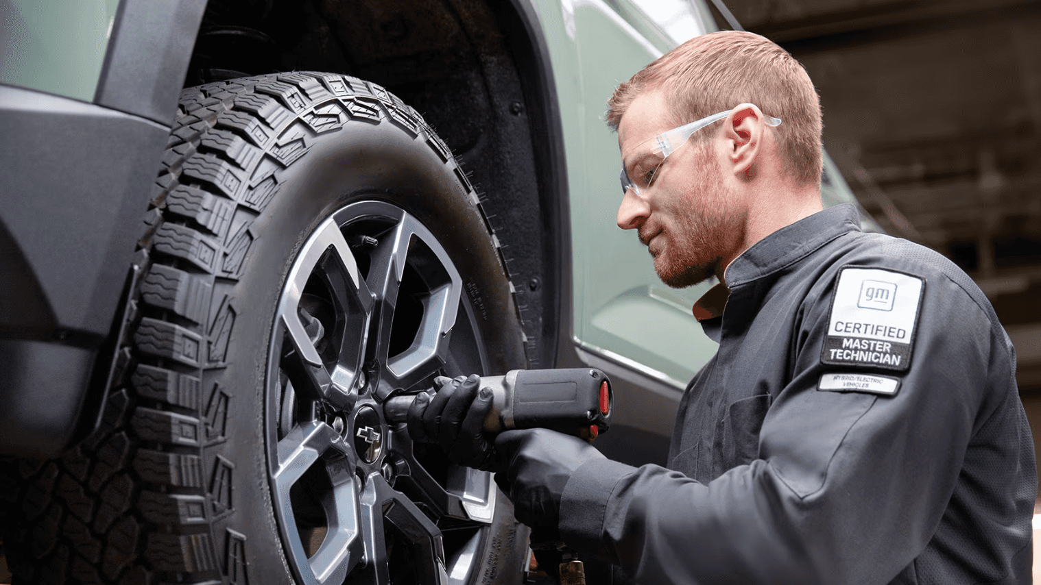 technician replacing a Chevy tire