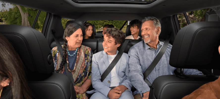 Family sitting in a new Chevy Traverse SUV near Wichita, KS