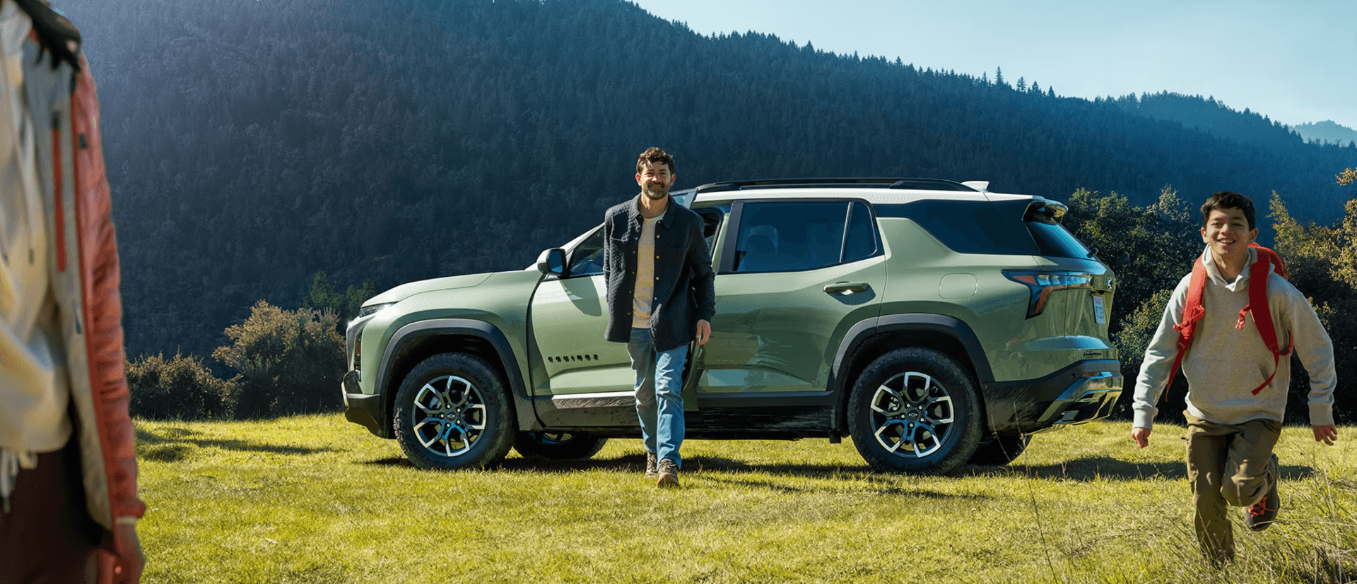 Family exiting a 2025 Chevrolet Equinox parked in the mountains