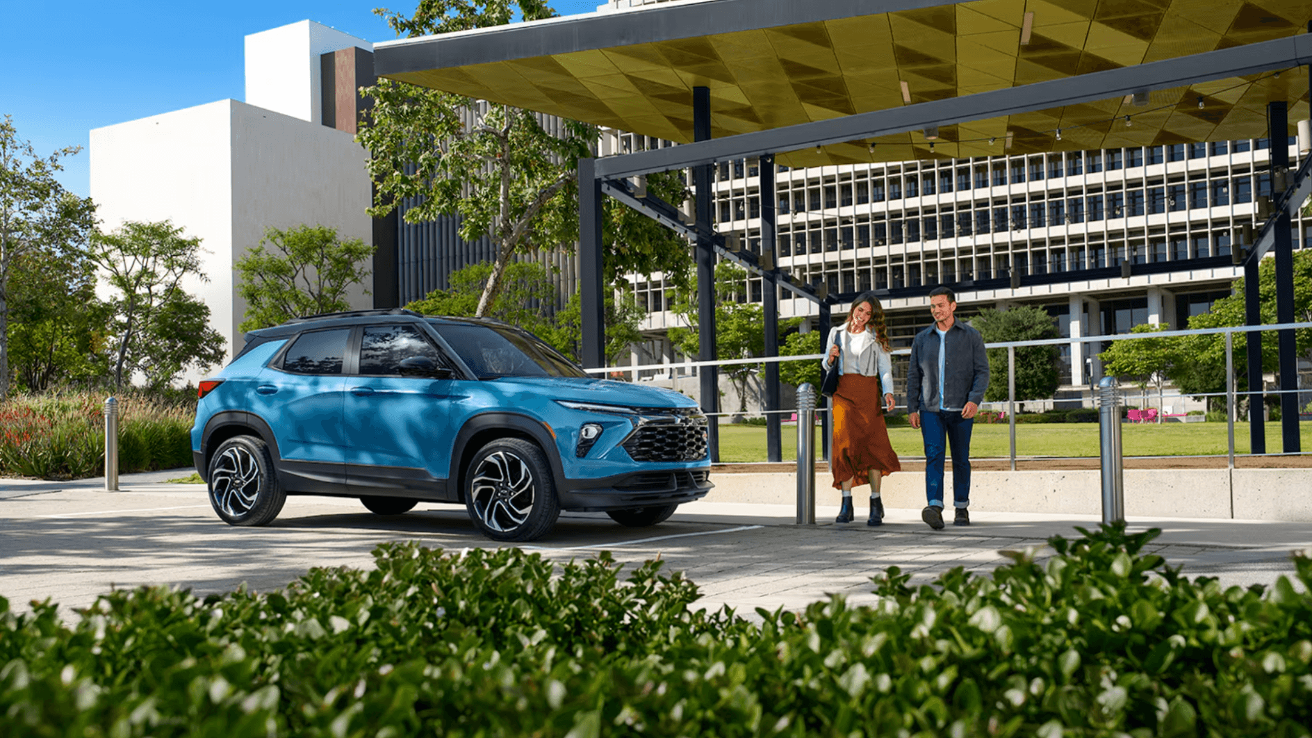 Couple approaching a 2025 Trailblazer at a park