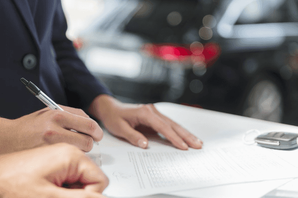 People sign a buy or lease a vehicle form