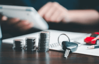 coins sit atop papers next to car keys