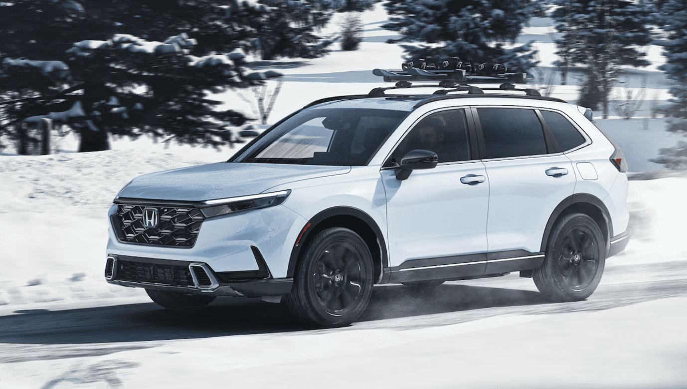 2024 white Honda CRV driving through snow