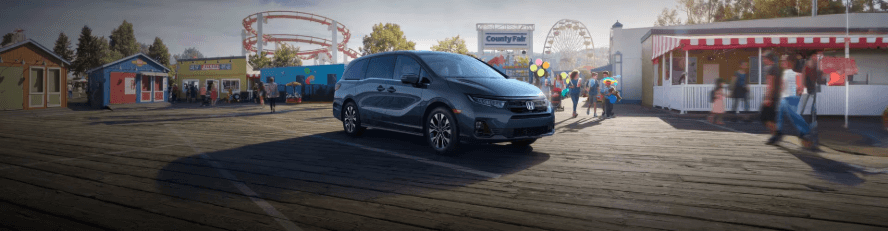 Honda Odyssey parked on a boardwalk fair