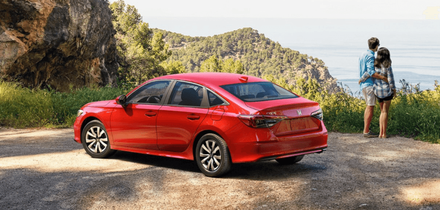 couple admiring a viewpoint near a new honda civic
