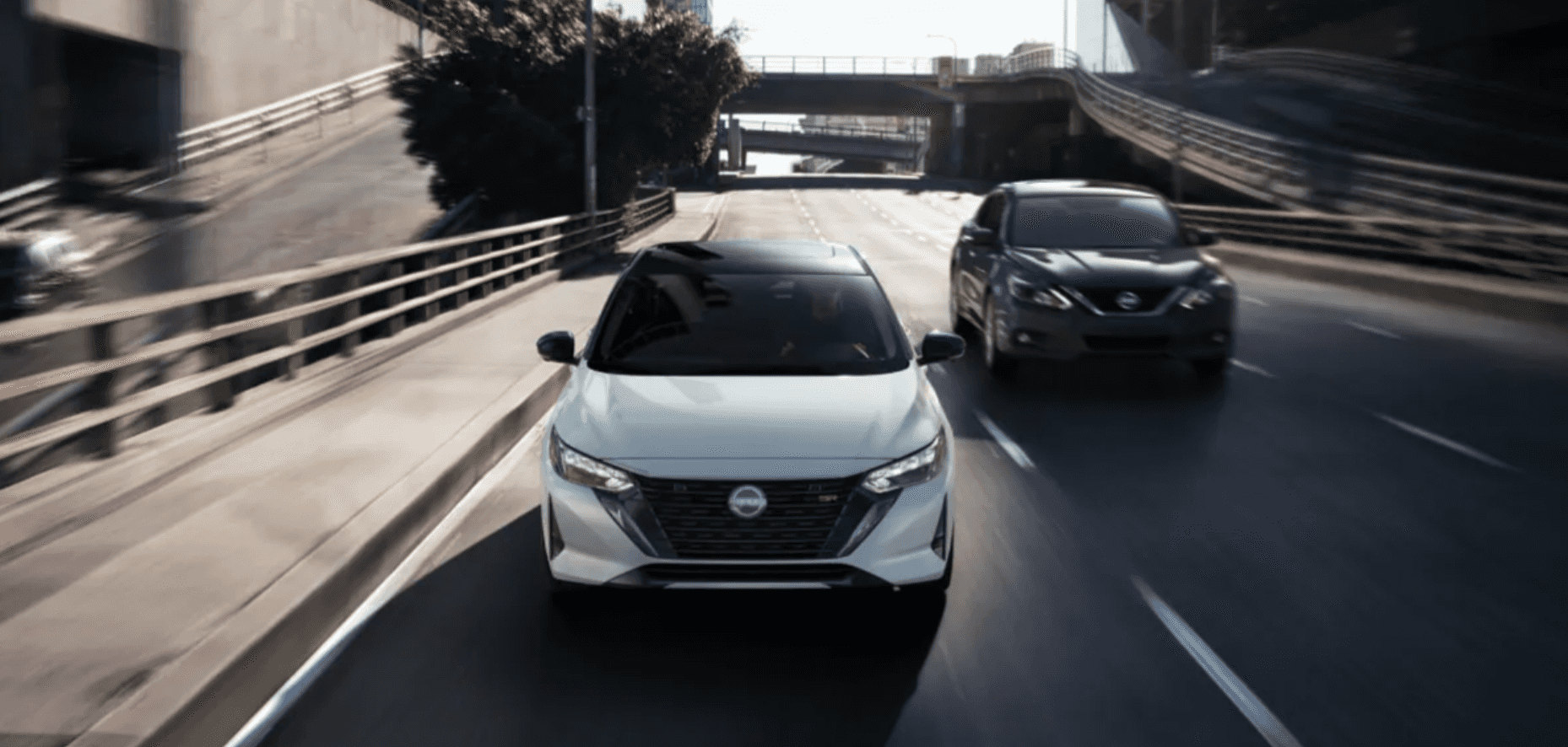 two new Nissan Sentra models driving on a highway
