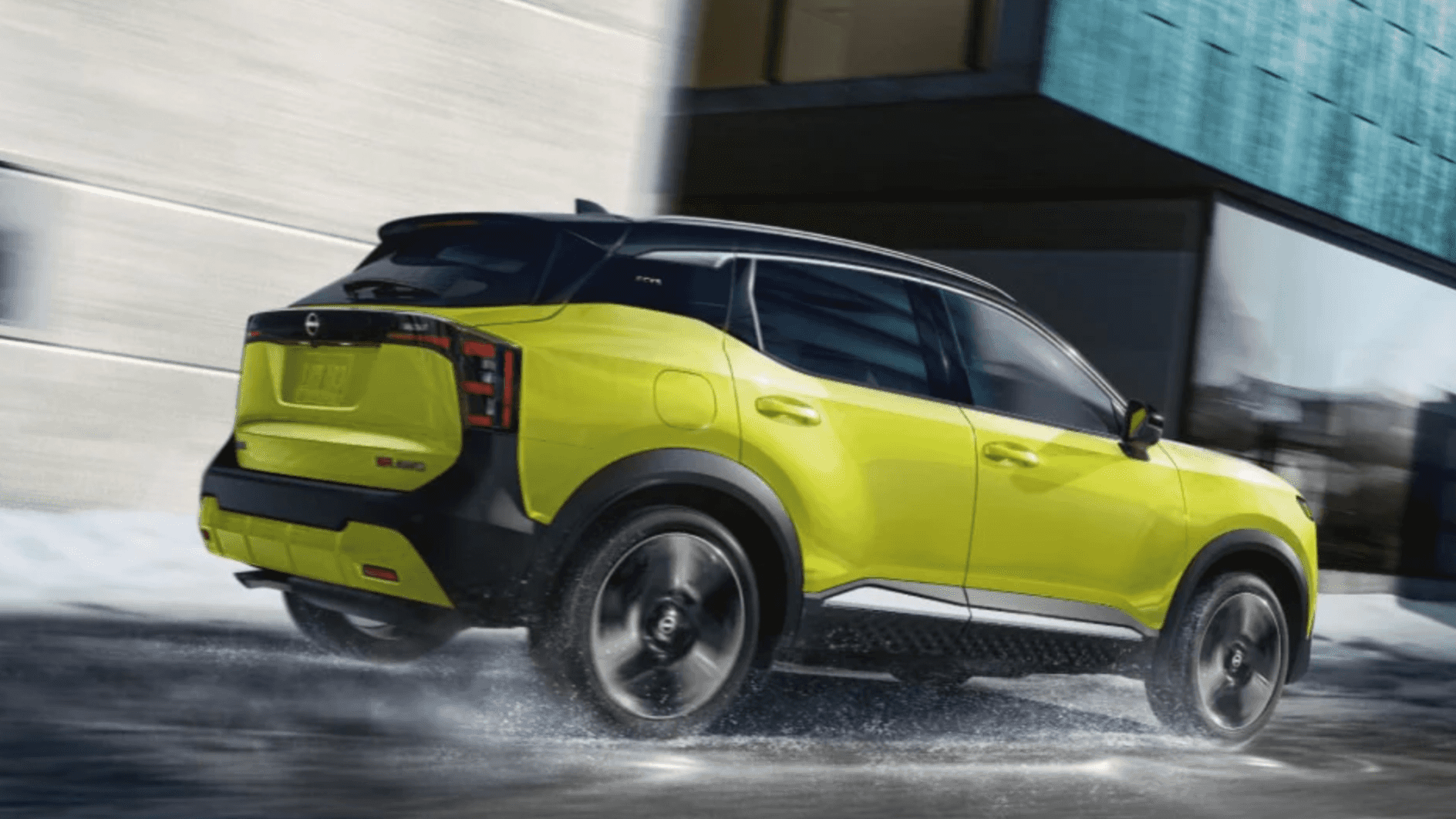 New 2025 Nissan Kicks driving through rainy streets
