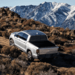 2024 Silver Honda Ridgeline driving up a mountain