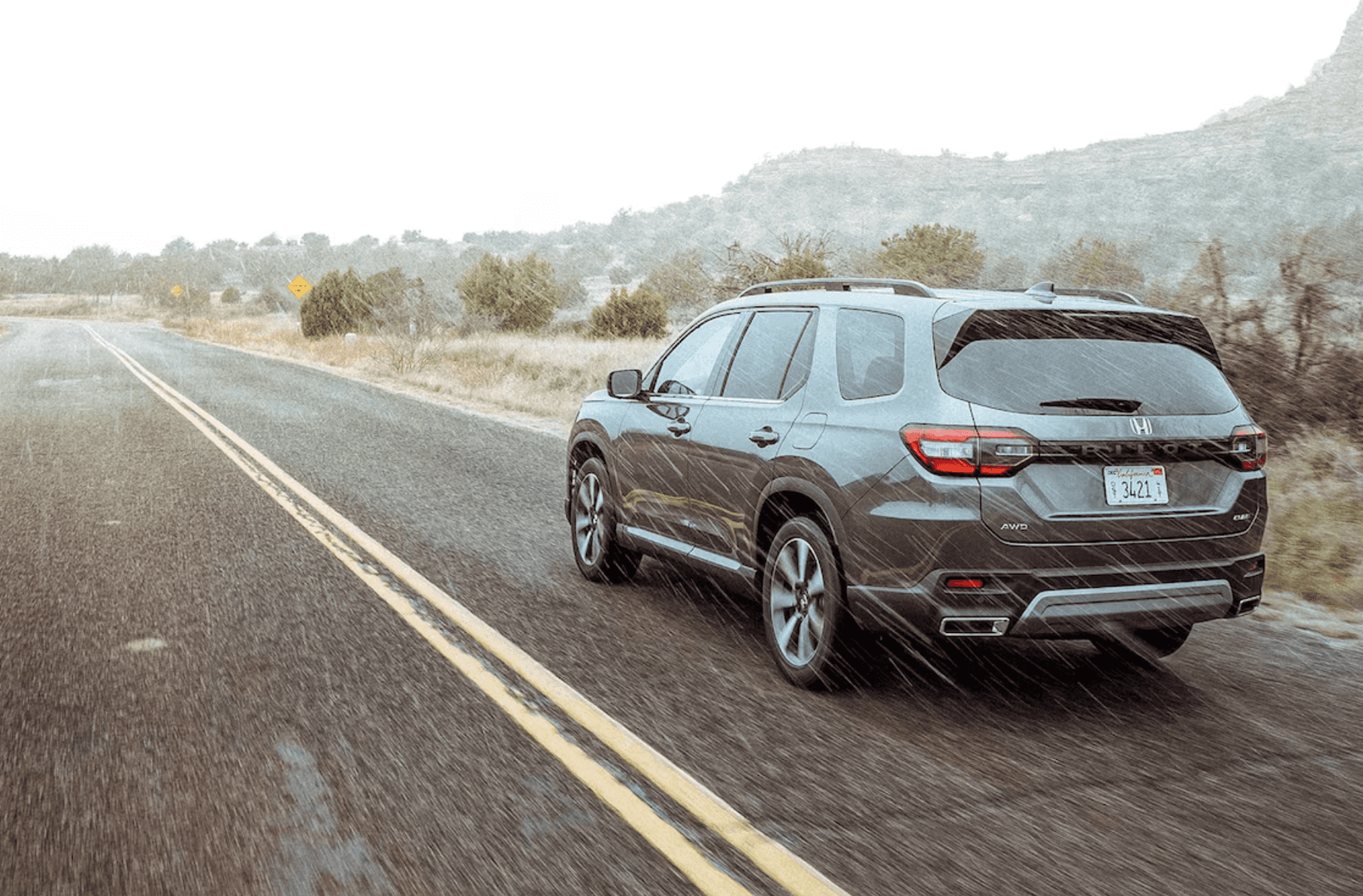 2025 Honda Pilot driving in the rain