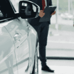 Close-up of new Honda mirror at Conklin Salina with people shopping in the background
