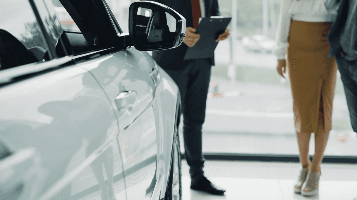 Close-up of new Honda mirror at Conklin Salina with people shopping in the background