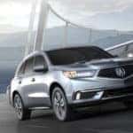 Acura MDX crossing a mysterious, fog-cloaked bridge