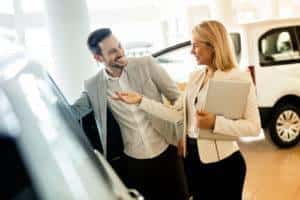 man-talking-to-woman-dealership-salesperson-2-dick-huvaeres-richmond-chrysler-dodge-jeep-ram-richmond-mi