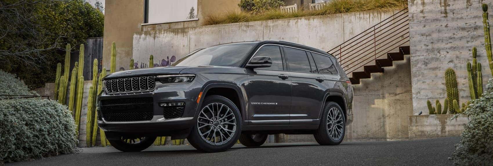 2021 Jeep Grand Cherokee L black parked in driveway