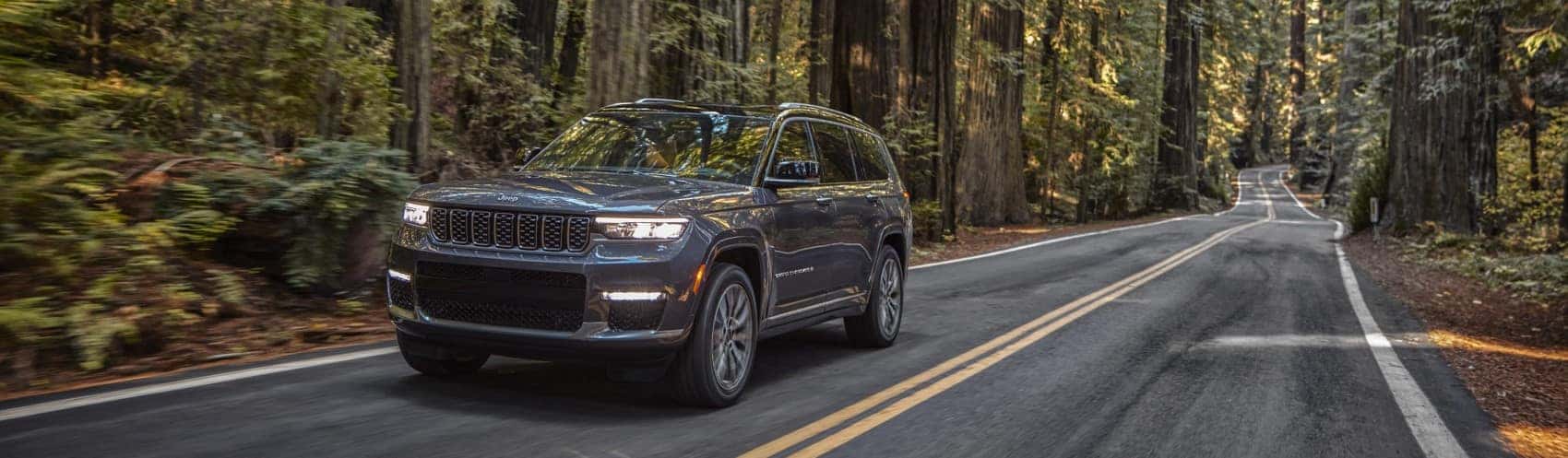 2021 Jeep Grand Cherokee L driving through redwoods