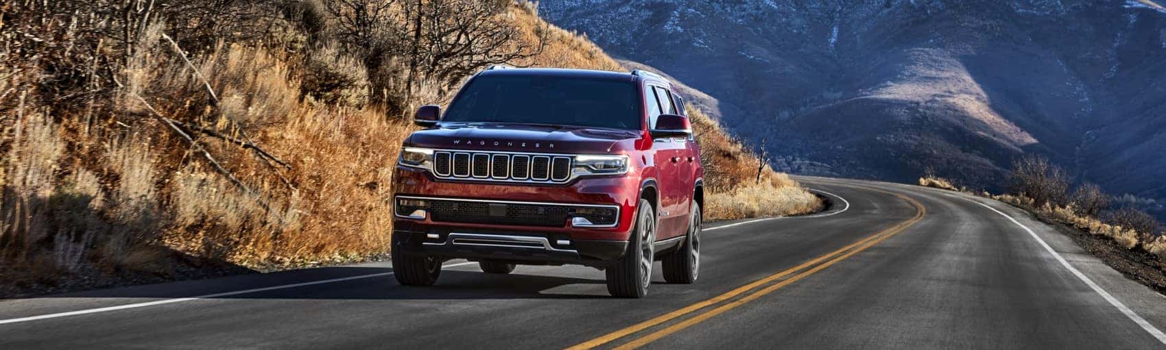 2022 Jeep Wagoneer red driving through mountains