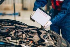 Mechanic installing car battery