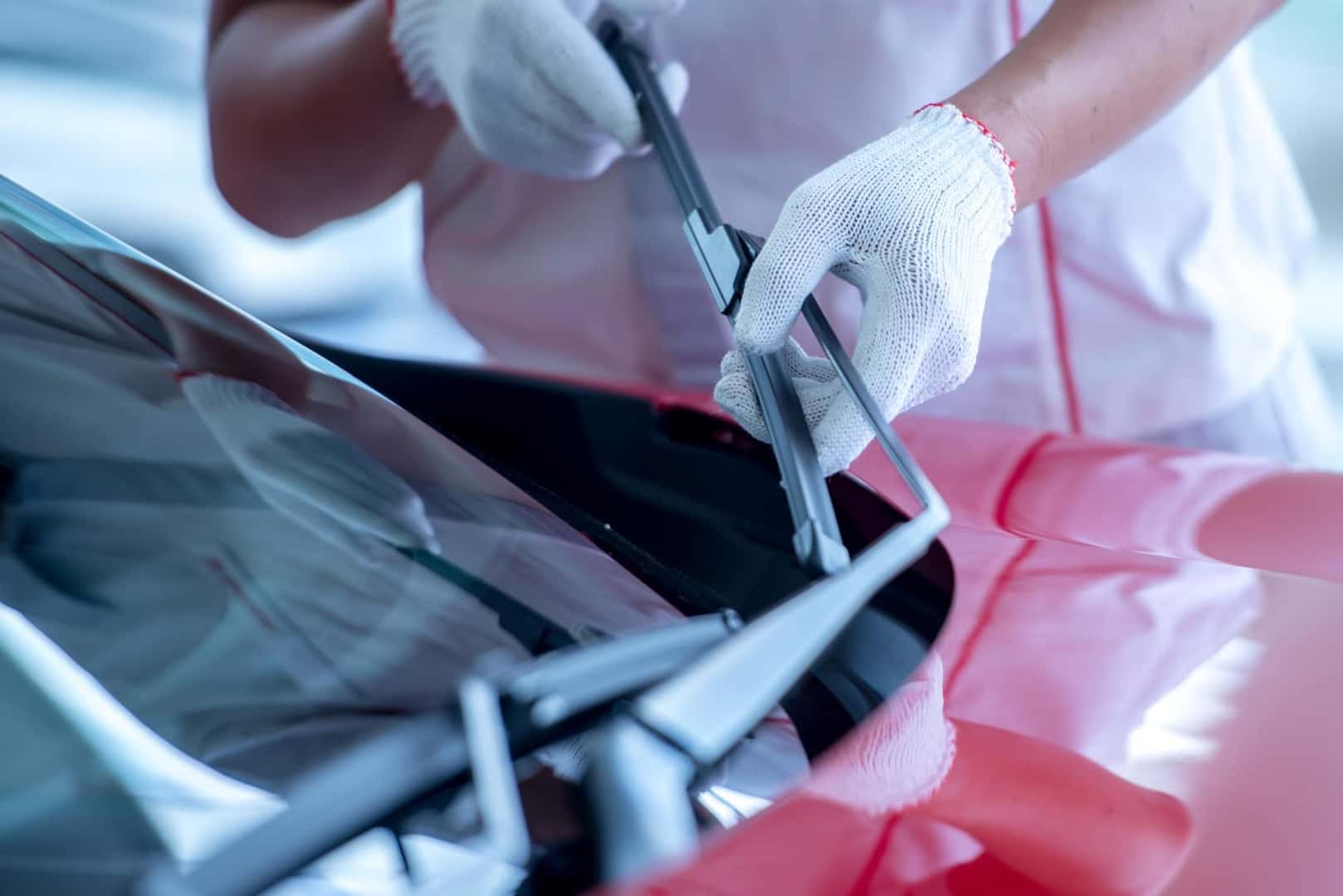 Service technician changing windshield wiper blades