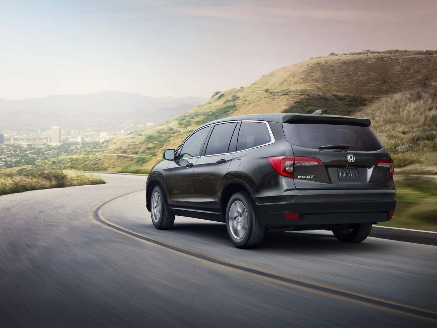 2021 Honda Pilot LX gray driving through mountains